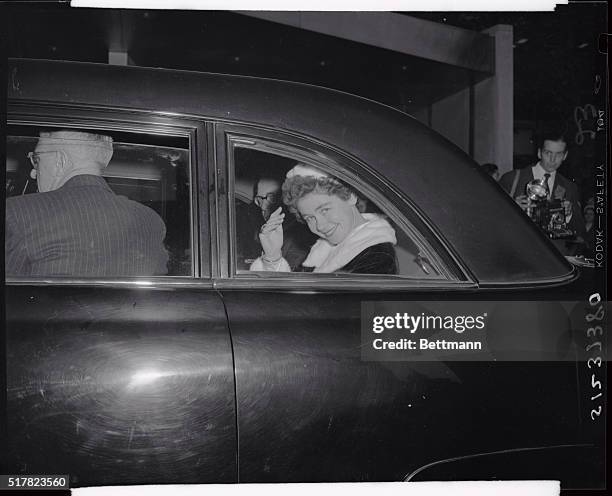 Vivacious Queen Frederika of Greece waves her hand in queenly gesture from her car window as she left the United Nations building after the visit she...