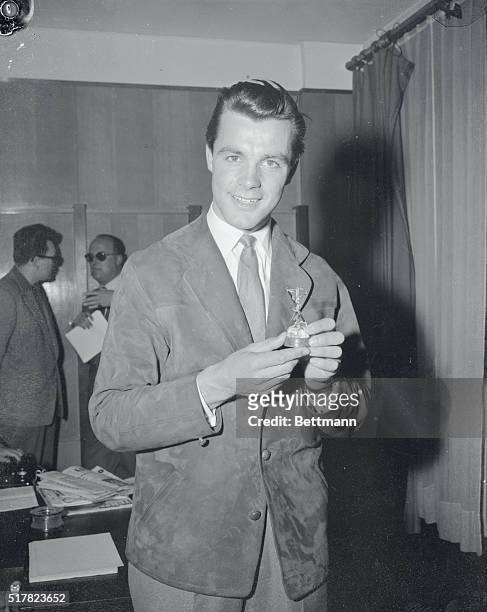 Triple Olympic champ Tony Sailer of Austria holds a golden ski award given him by a Paris newspaper at a reception in the French capital. The...