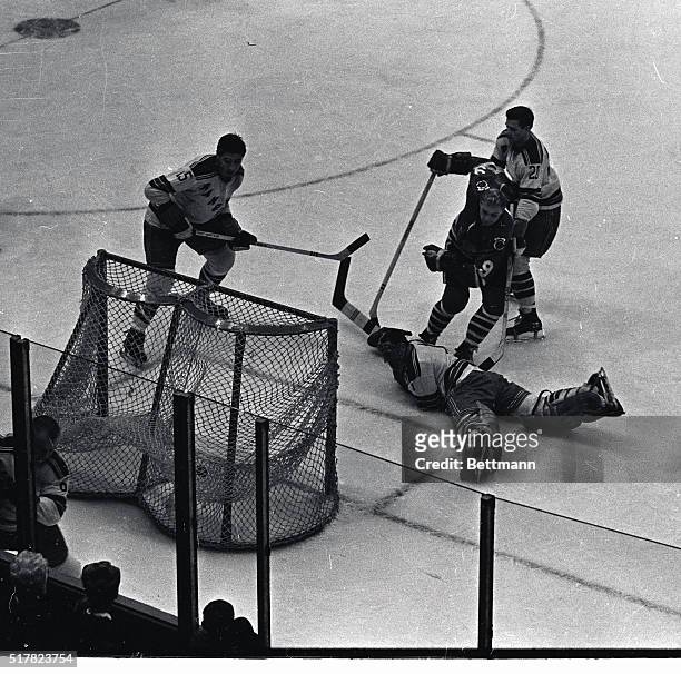 Black Hawks left wing Bobby Hull scores in the first period as puck lands in the net, left, past the sprawled figure of New York Rangers goalie...