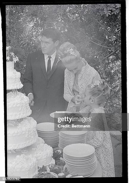 Tippi Hedren and husband are shown at their wedding cake.