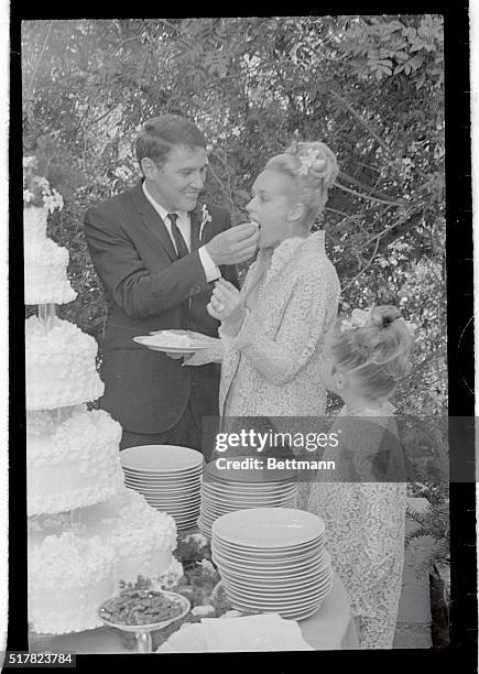 Tippi Hedren with husband are shown at their wedding cake.