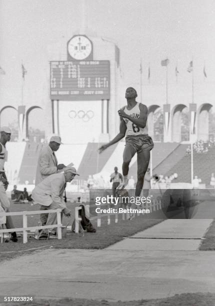 Ralph Boston of Nashville, Tennessee, officially breaking the world's long jump record in the final U.S. Olympic Track and Field Trials is shown with...