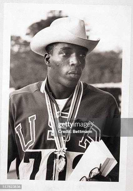 Tokyo, Japan- America's Bob Hayes, winner of the gold medal in the Olympic 100-meter dash, is flanked by silver medalist E. Figerola of Cuba and...