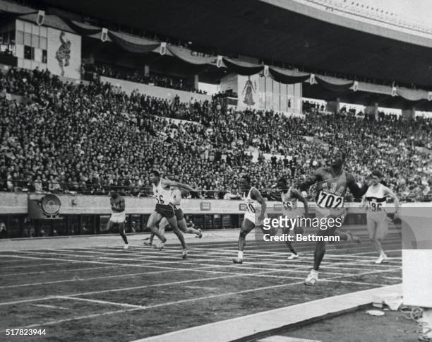 The finish of the Olympic 10 meter final here October 15th shows America's Bob Hayes breaking the tape to tie the world record. Hayes ran the fastest...