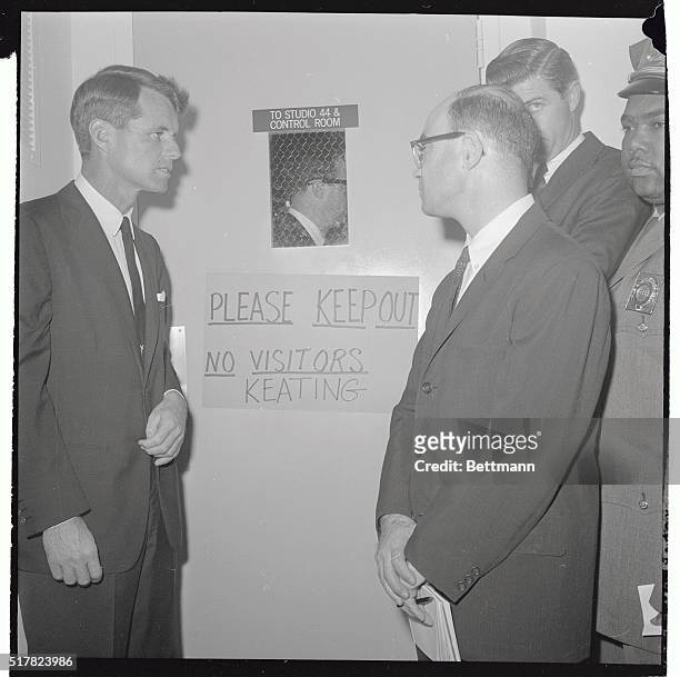 Robert F. Kennedy, Democratic candidate for Senator, reads a sign on the door of the CBS studio barring his entry during a televised "debate"...