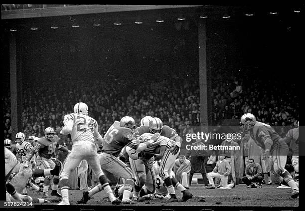 Baltimore Colts quarterback John Unitas watches left end Raymond Berry head out into a pass pattern in the fourth quarter here 11/22. Unitas had a...