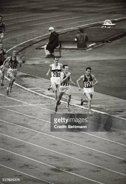 In a come-from-behind stretch run, Bob Schul of the U.S.A. Wins the 5000 meter race. Schul is shown passing Michael Jazy of France. Jazy is...