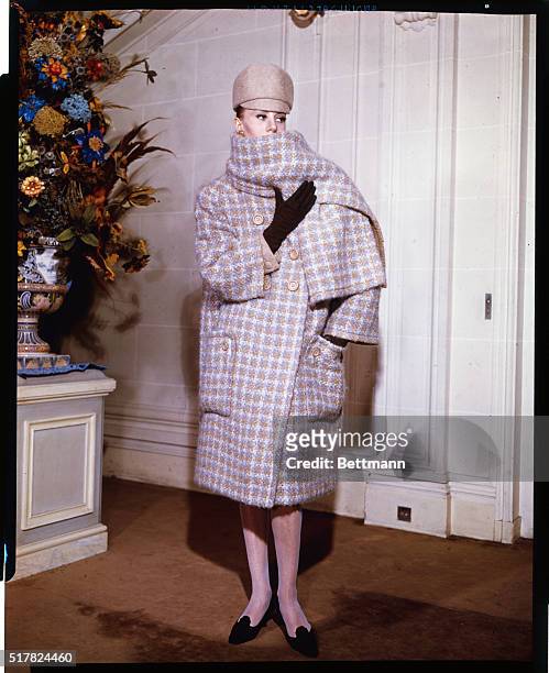 High 'n' Wide...Stressing the "bulky" look in coats, Marc Bohan creates this ensemble for the Paris Dior collection for Fall 1963. A giant checked...