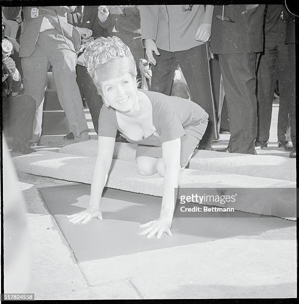 Actress Debbie Reynolds puts her hands in cement in the forecourt of Grauman's Chinese Theater. She became the 148th film celebrity to be honored by...