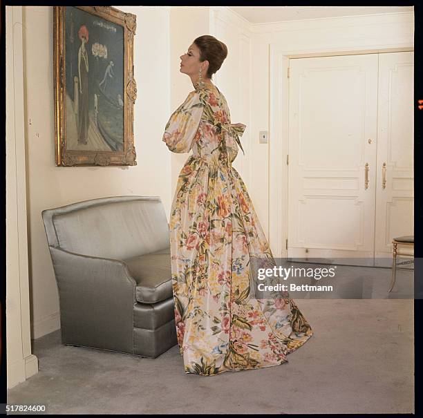 Flowers for milady...Norman Norell offers flowers to milady with this soft yellow, floral printed, housegown from his Fall 1963 collection. New...