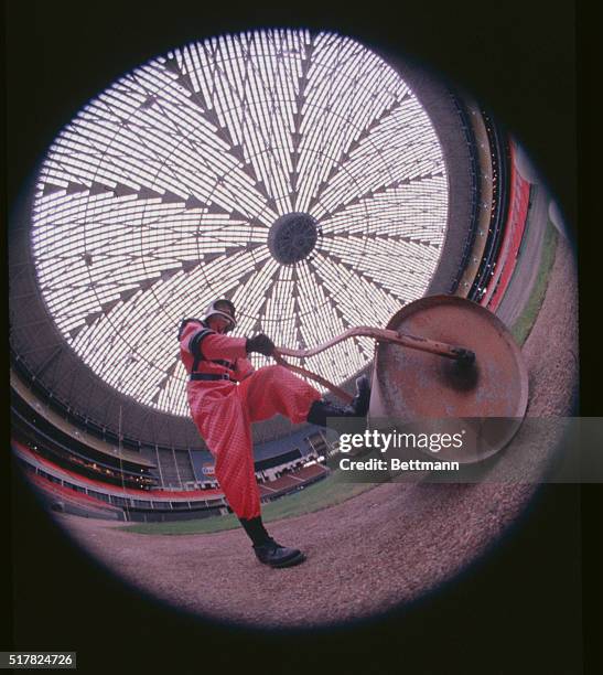 Houston, Texas: The "fisheye" lens captures this weird view of an Astrodome stadium grounds keeper, wearing the space suit of Astro baseball club...