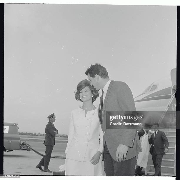 Italian actress Claudia Cardinale and actor Rock Hudson shown arriving here 3/12 from location scenes in Florida and New York for their new film,...