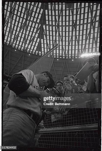 Yankee slugger Mickey Mantle obliges some youngsters with his autograph prior to exhibition game with Houston Astros that officially opened the new...
