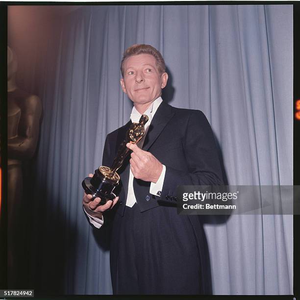 Annual Academy Awards: Danny Kaye holds oscar during the presentations.
