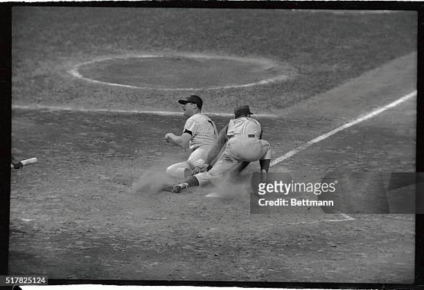 New York Yankees' outfielder Mickey Mantle grimaces in pain as he slides into home plate during 4th inning of second game of twi-night doubleheader...