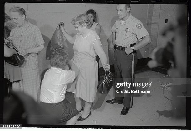 Matron searches a woman on hand to witness the arraignment of Richard Speck, the accused slayer of the eight student nurses. All spectators were...