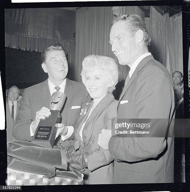 Hollywood, California: Governor-elect Ronald Reagan, a former president of the Screen Actors Guild, makes a special presentation to actress Barbara...