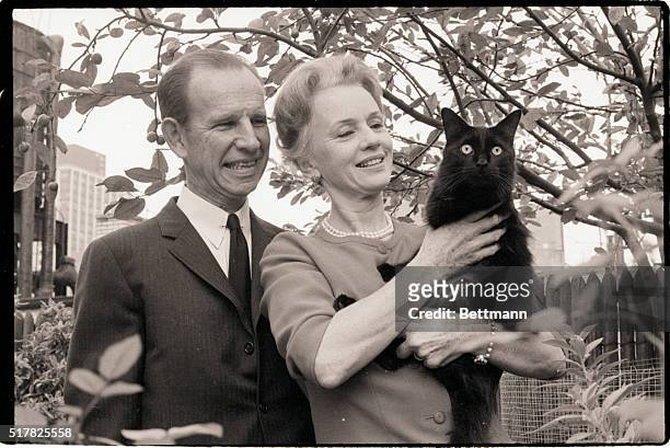 New York, NY: Actors Hume Cronyn and wife, Jessica Tandy, holding their cat, on the terrace of their New York penthouse apartment.
