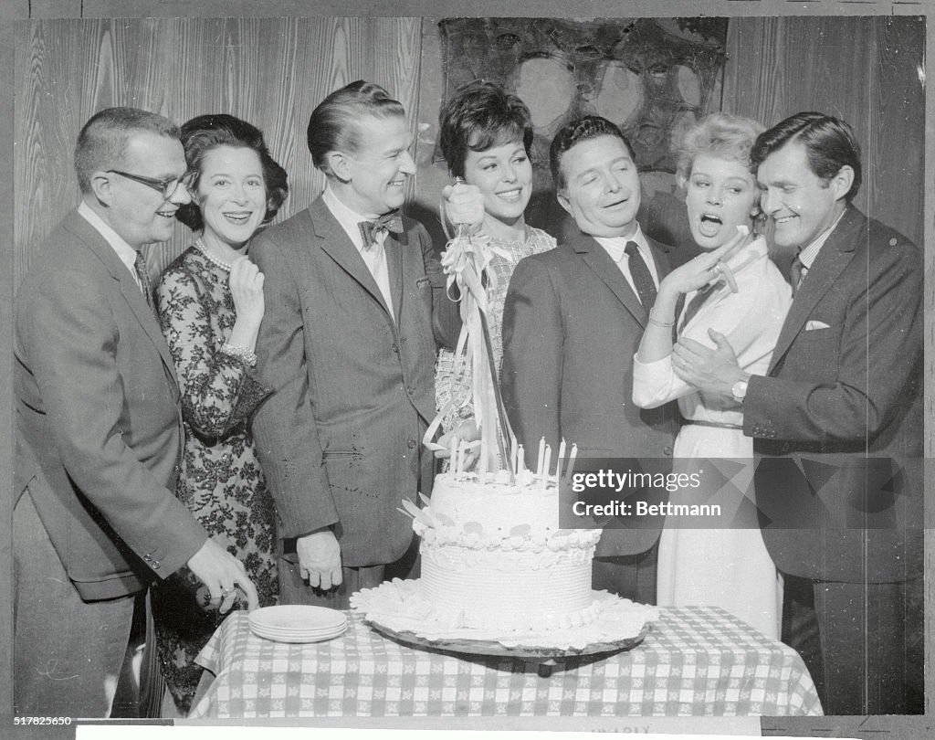 Game Show Stars Grouped Around Cake
