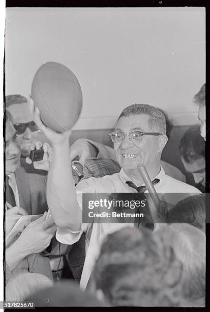 Victorious coach Vince Lombardi holds football a loft as he facially expresses his feelings about the NFL win over the AFL win over the AFL and the...