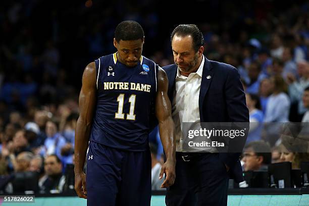 Demetrius Jackson of the Notre Dame Fighting Irish talks with head coach Mike Brey late in the second half against the North Carolina Tar Heels...