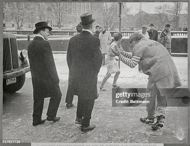 Stockholm, Sweden: Keeping Protest At Alm's Length. Top-hatted members of Parliament walk past a "begging" demonstrator as they leave the opening...