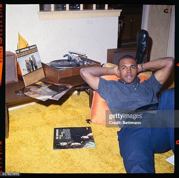 S overwhelming choice for NFL Rookie of the Year, Chicago Bear's Gale Sayers relaxes at home. Sayers won scoring honors with 22 touchdowns as he...