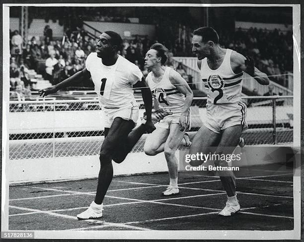 Florida A&M's Bob Hayes , world record-holder, breaks the tape to win the 100-yard dash in the opening of a US-British track meet at the White City...