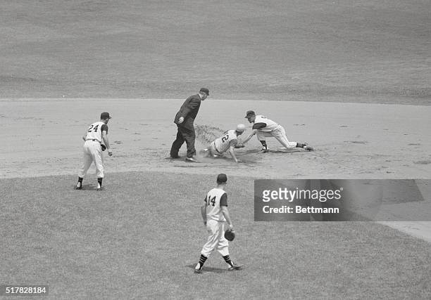 Pittsburgh, Pennsylvania: Pirate second baseman Bill Mazeroski puts tag on Cincinnatis' Billy Martin as he tried to stretch single into a double in...