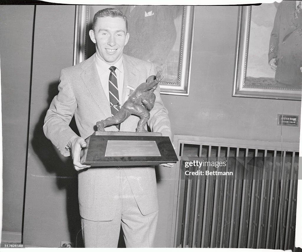 Johnny Lattner Holding Heisman Trophy