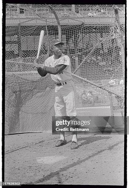 Hank Aaron, the Milwaukee Brave is shown in the "batting cage" in this photograph.