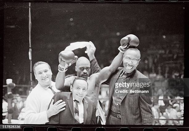 Jubilant Ruben "Hurricane" carter whoops it up with his manager and trainers after winning fight with Farid Salim, the middleweight champion of...