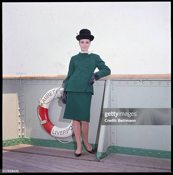 Gentle look...The costume look becomes gently tailored in this empire green wool twill suit by Pauline Trigere, emphasized by one sided closing and...