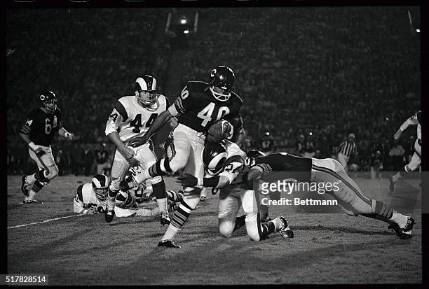 Chicago Bears Gale Sayers is hit by Los Angeles Rams defensive back Clancy Williams as Sayers went for an eight yard gain during the first quarter of...