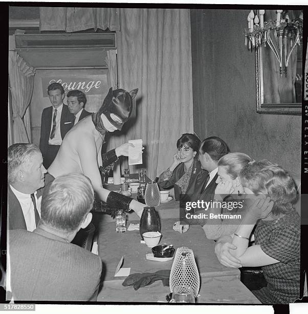 Topless waitress who calls herself "Batgirl" wears appropriate mask as she serves drinks to customers at the Crystal Room her Nov. 10th, as the club...