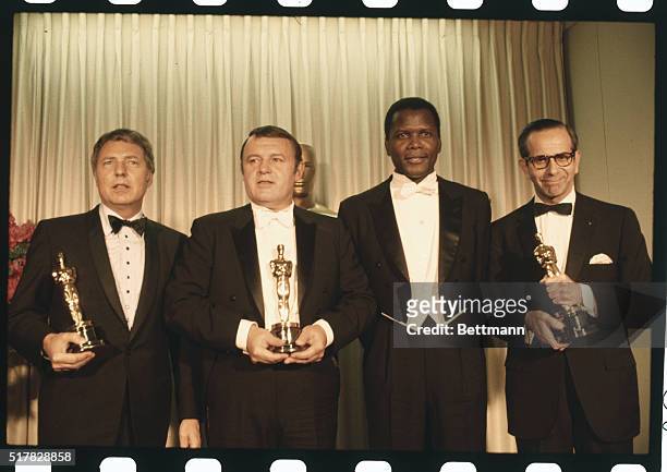 Rod Steiger with Sidney Poitier, and two unidentified men after Steiger and the two men were awarded Oscars at the Academy Awards presentations.