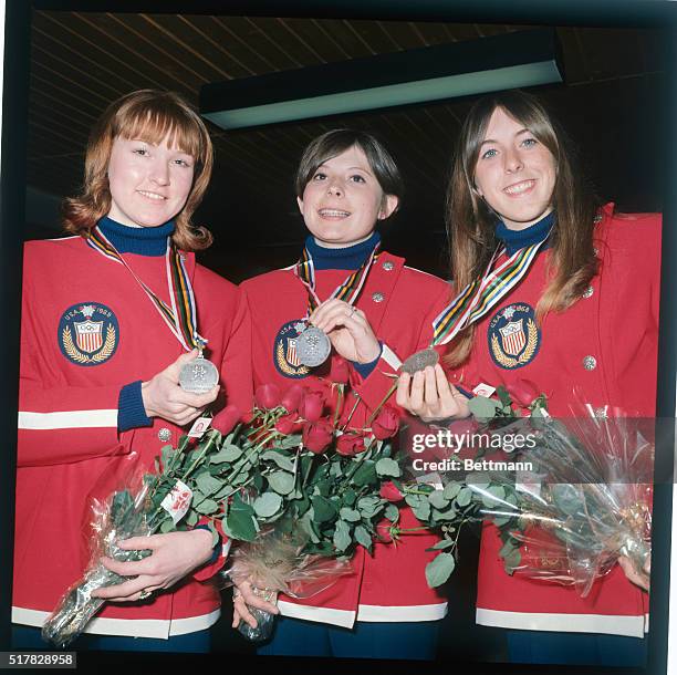 Grenoble: Three happy American speed skating girls display their Olympic Silver medals they won for all placing second behind Russia's Ludmilla...
