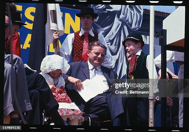 German Minister of Finance, Franz Josef-Strauss is shown with man and children in national costume at the Silesian Refugees Meeting Rally.