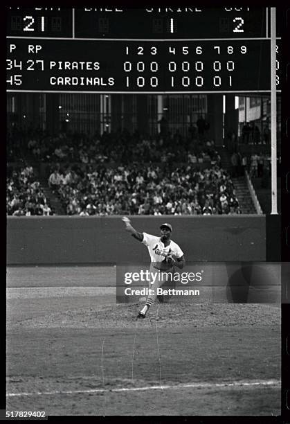 St. Louis Cardinals pitcher Bob Gibson strings out the zeroes on the opposition scoreboard as he pitches consecutive shutout, against the Pittsburgh...