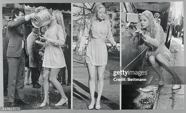 New York: Candy Scene. Actress Ewa Aulin gets doused with water from a bucket, shivers, and crouches in hiding behind a car, during the filming of a...