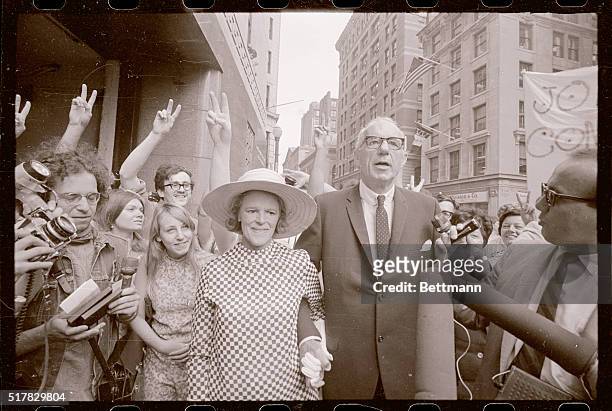 Famed baby doctor, Dr. Benjamin Spock, holding hands with his wife, arrives at Boston Federal Court building. For sentencing. He and three other...