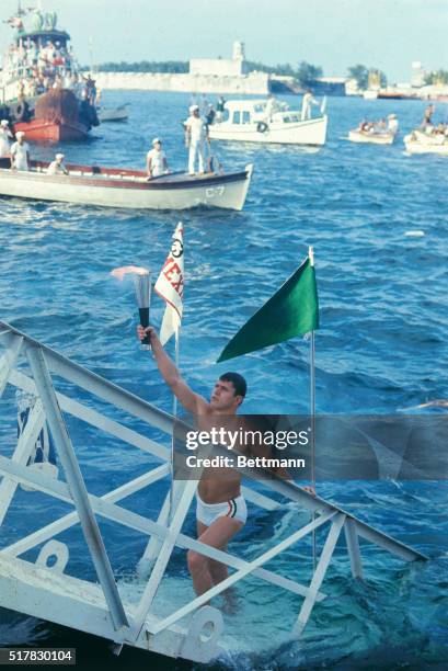 With thousands of spectators cheering the Olympic flame is carried onto Mexican territory 10/6 following it's 6 week journey by land and sea from Mr....