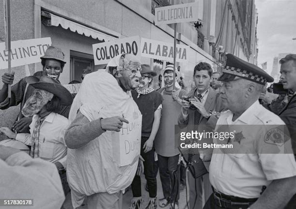 Masked Yippie member argues with a policeman, as the Yippie rehearsed for a demonstration in front of a downtown hotel here. The rehearsal was a...