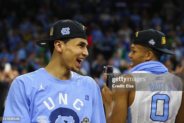 Marcus Paige and Nate Britt of the North Carolina Tar Heels celebrates by cutting down the net after defeating the Notre Dame Fighting Irish with a...