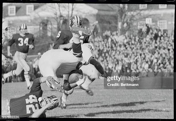 Yale's Cal Hill, does a somersault, as he is tripped up by Harvard's John Ignacio, during the first quarter action as Hill made a short gain on the...