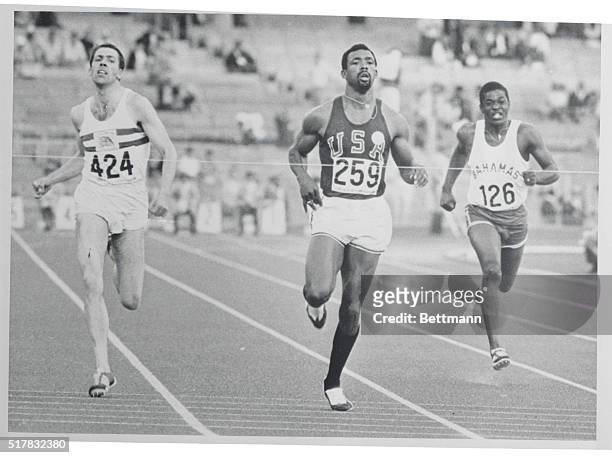 Mexico City: USA's John Carlos gets to the tape looking almost relaxed to win the men's 200-meter dash, 2nd round heats, 10/15. Richard Stene of...