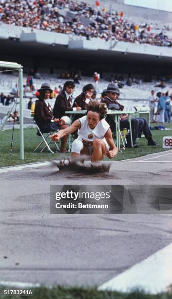 Rumania's Viorica Viscopoleanu, one knee bandaged, leaps 22 feet, 4-1/2 inches to win an Olympic Gold Medal and better the official world and Olympic...