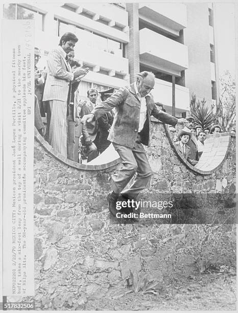 Mexico City: Mexican President Jose Lopez Portillo, a physical fitness buff, takes a six-foot leap from the top of a wall during a visit 2/21 to the...