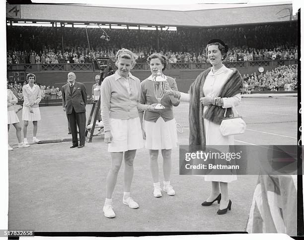 The Duchess of Kent photographed presenting the cup to Miss L. Broughand Mrs. DuPont, after they had beat on Miss D. Hart and Miss Fry in the Women's...