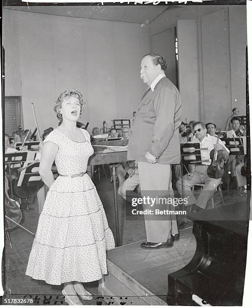 French actress Denise Darcel rehearsing for her debut as symphonic soloist at the Lewisohn Stadium for the galary all French program celebrating...